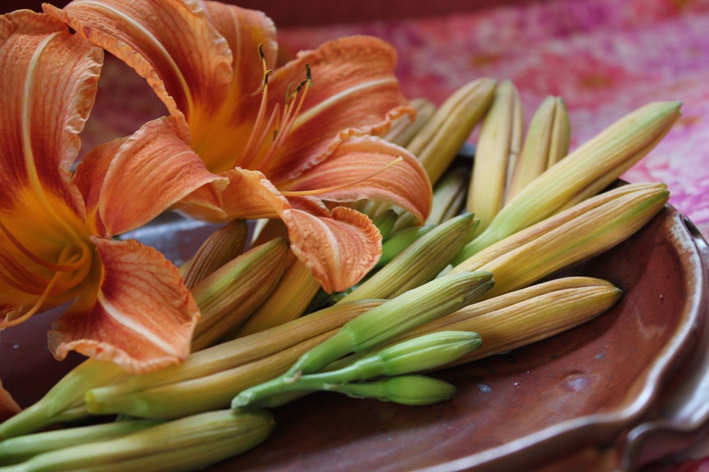 Fresh daylily buds on a platter.