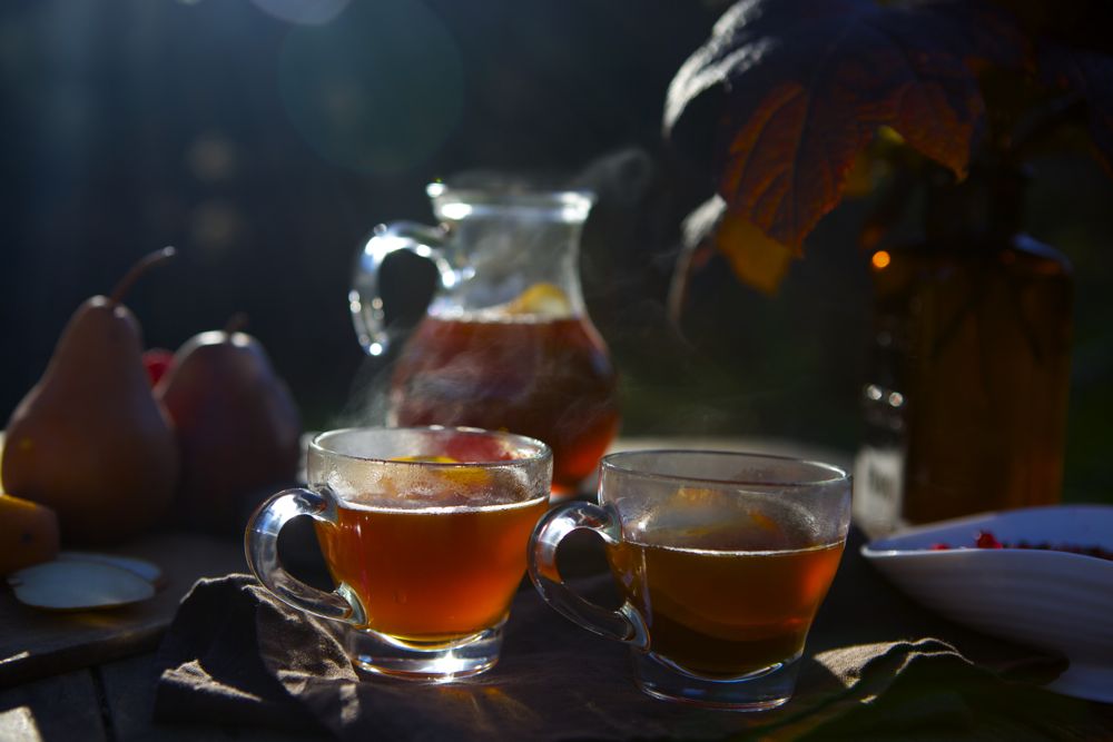 Two steaming cups of Spiced Hawthorn Pear Persimmon Brandy.