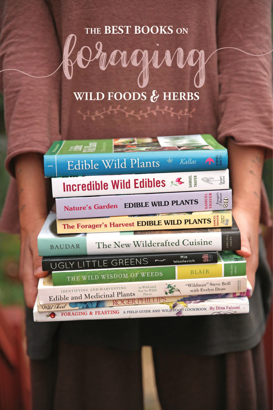 Hands holding a stack of books about foraging.