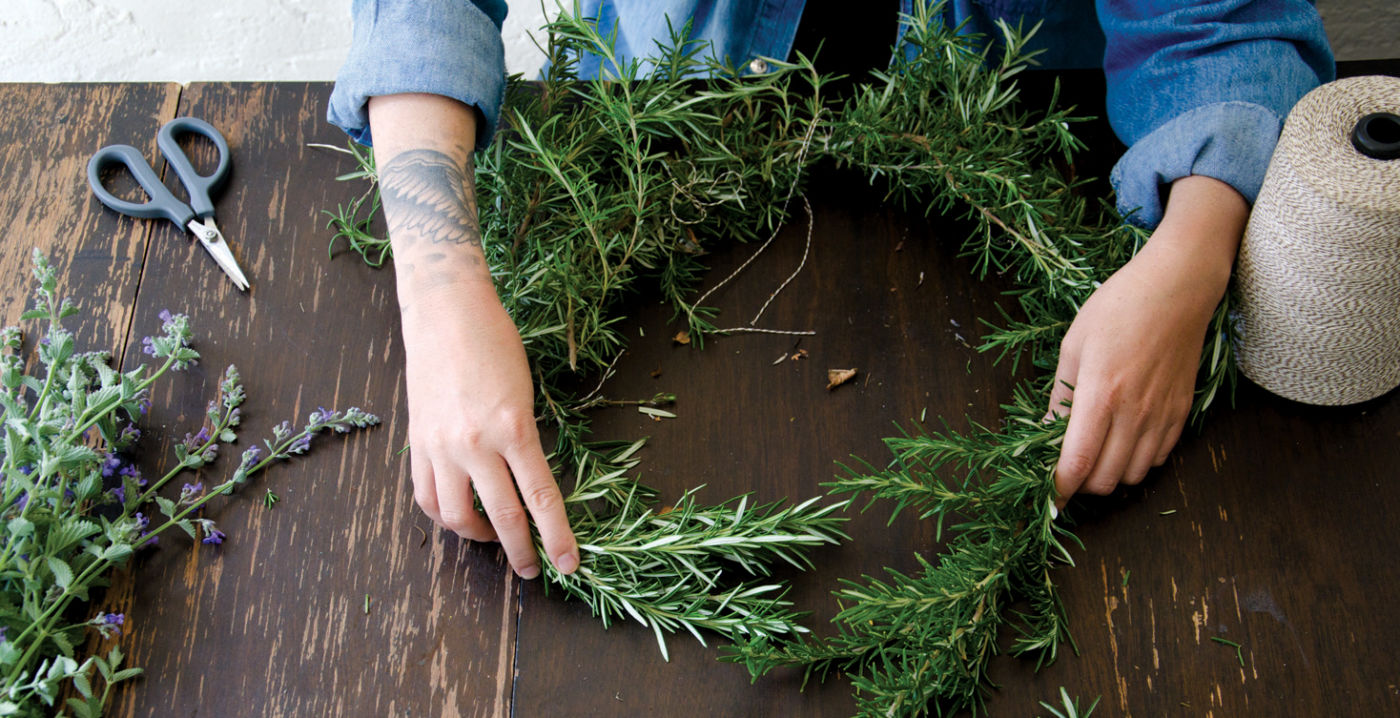 Step 1: Start by cutting long sections of woody rosemary branches to build the frame for the wreath.