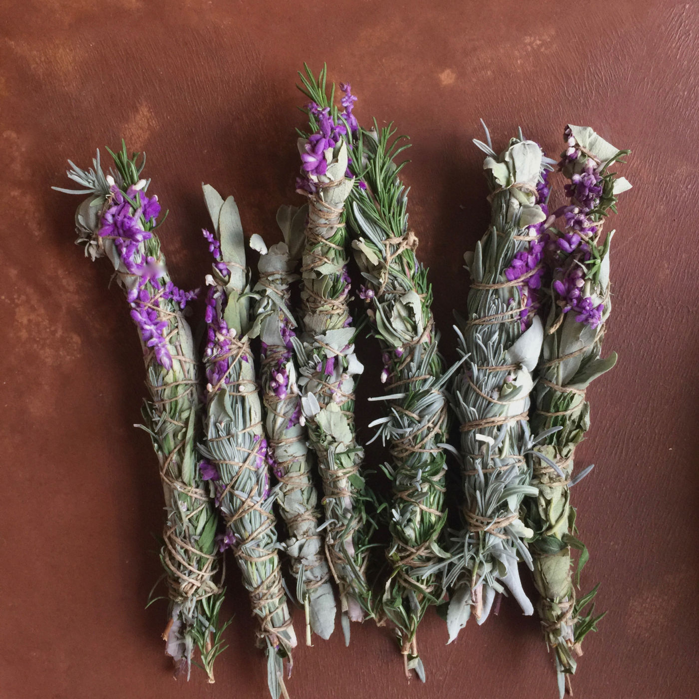 Homegrown aromatic smoke sticks prepared from white sage, lavender, rosemary, and Mexican sage.