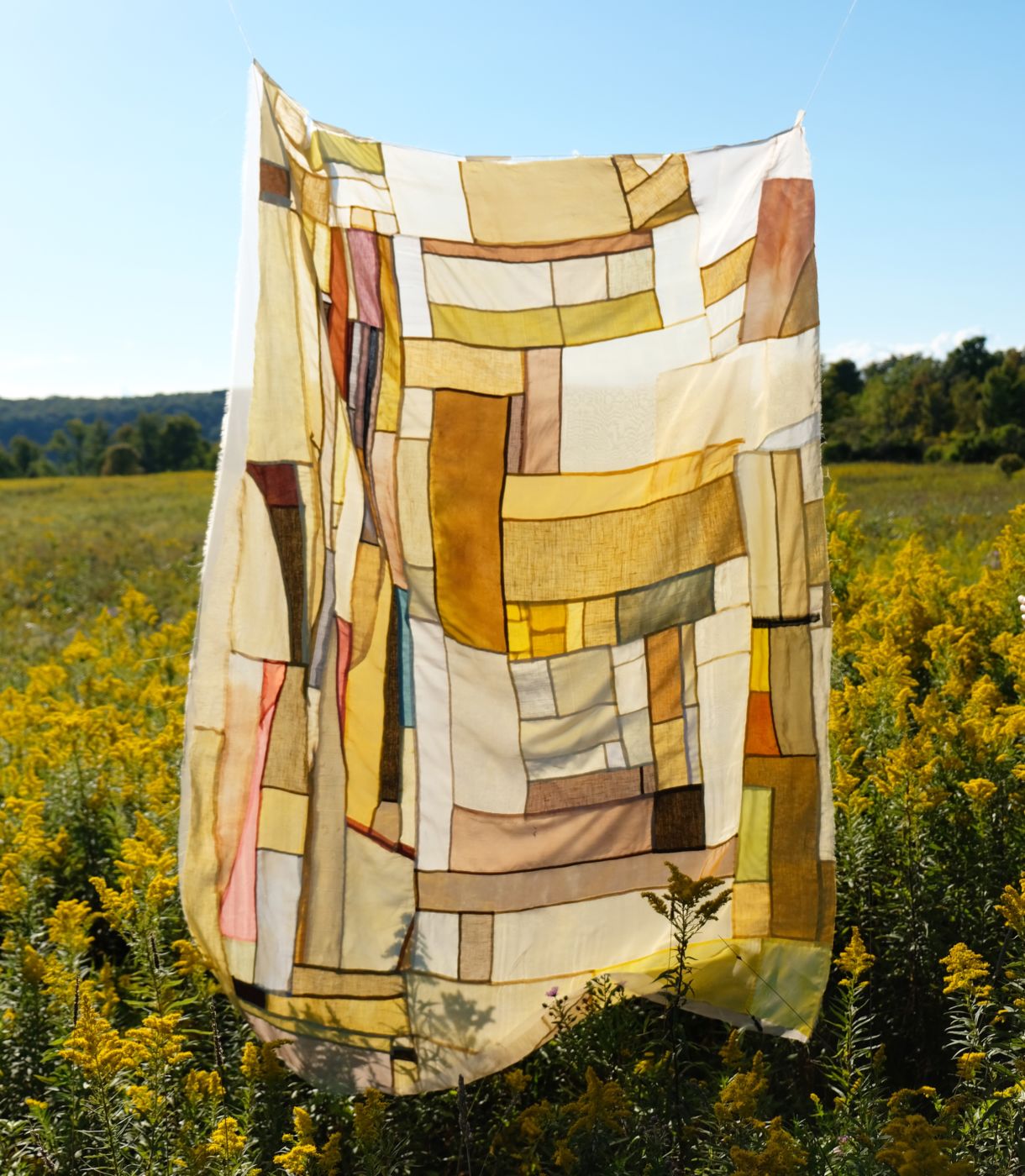 Handmade botanically dyed quilt using goldenrod, turmeric, onion, and sumac. Quilt, dyes, and photo by Kiva Motnyk of Thompson Street Studio.