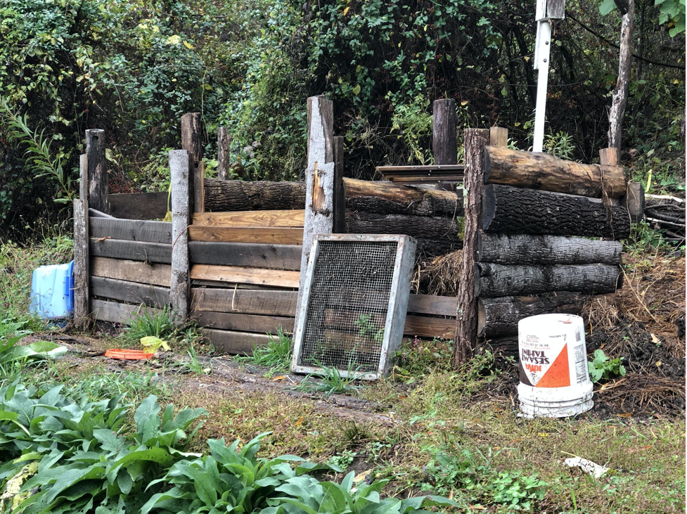 Soul Gardens Eco-Community has a three-bin compost system made of scrap lumber. The screen in the foreground is used to sift the compost for use in their homemade seed-sowing medium.