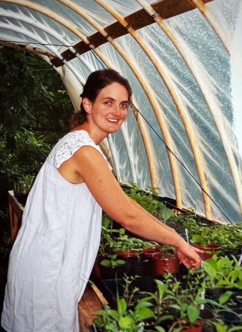 Juliet Blankespoor becoming an herbalist: tending to her herb seedlings in her first greenhouse.