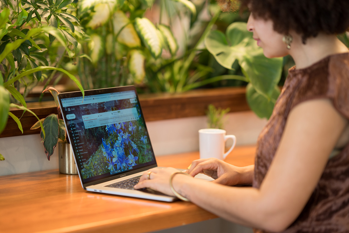 An herbalist using a laptop.